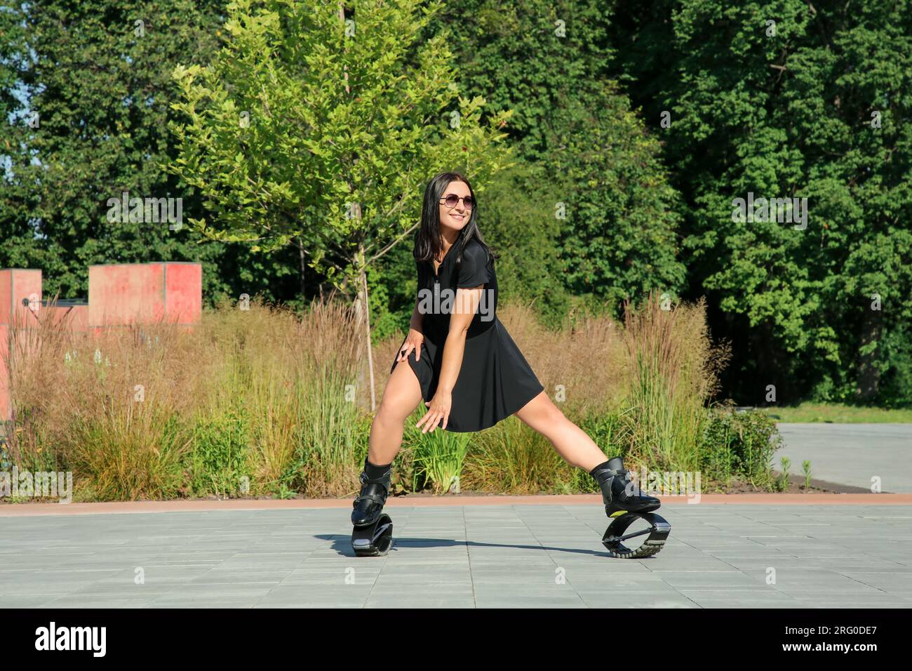 Woman doing exercises in kangoo jumping boots outdoors Stock Photo Alamy
