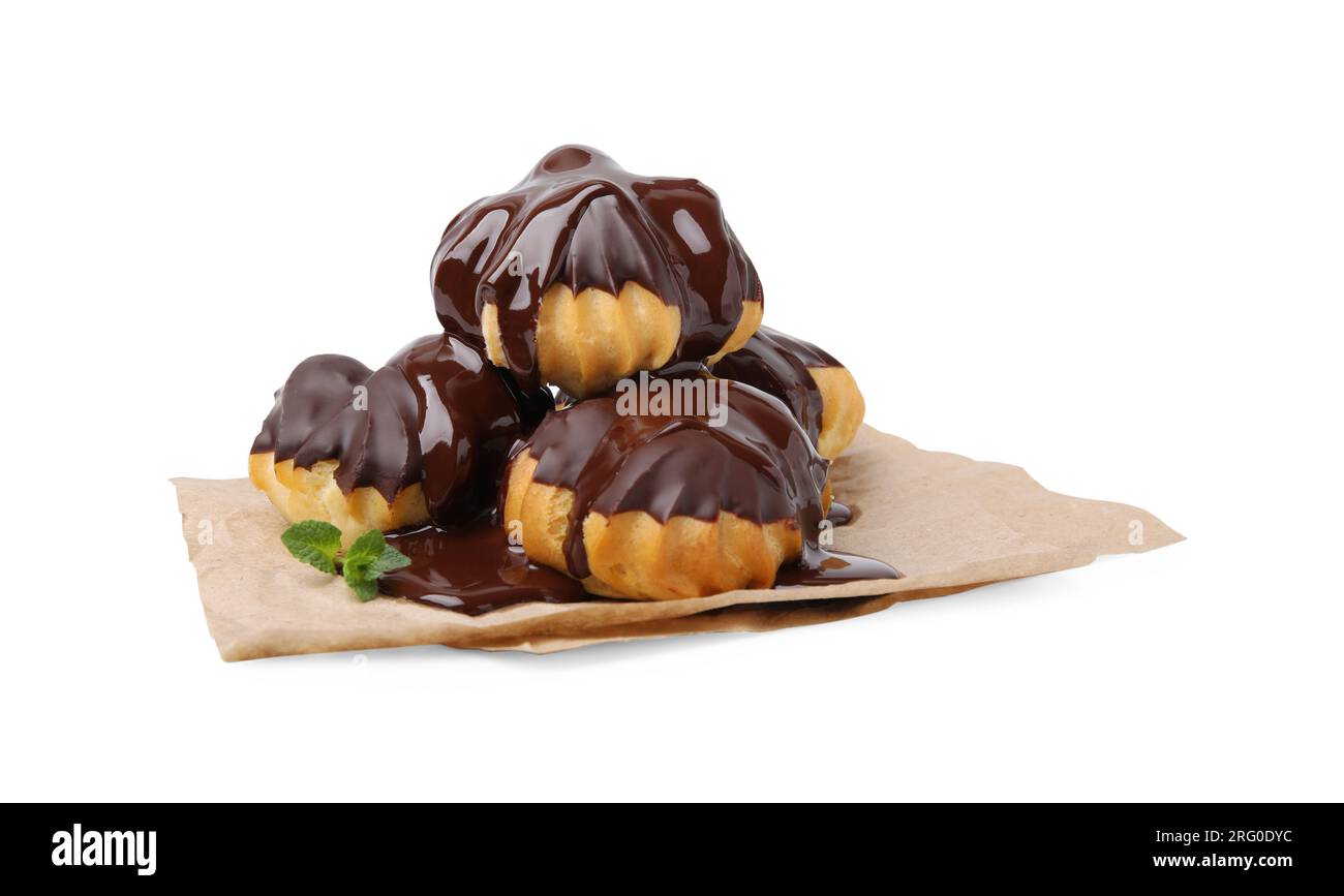 Delicious profiteroles with chocolate spread and mint isolated on white