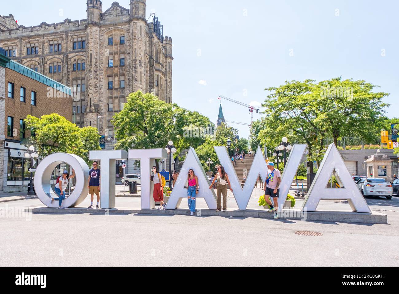 Tourists pose for photographs at the large Ottawa sign located in the Byward Market area of downtown Ottawa. Stock Photo