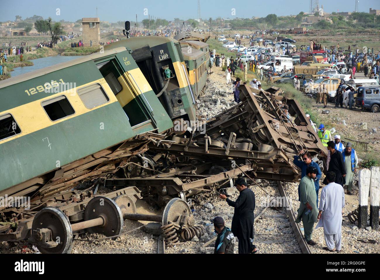 (230807) -- SANGHAR, Aug. 7, 2023 (Xinhua) -- People gather near derailed coaches of a passenger train in Sanghar district of Pakistan's southern Sindh province, on Aug. 6, 2023. At least 22 people were killed and over 50 others injured on Sunday after a passenger train derailed in the Sanghar district of Pakistan's southern Sindh province, local police said.The accident took place when 10 coaches of the Hazara Express train derailed when it was crossing a canal bridge near Sarhari town in the Shahdadpur area of the district, Muhammad Younis Chandio, deputy inspector general of police of the r Stock Photo