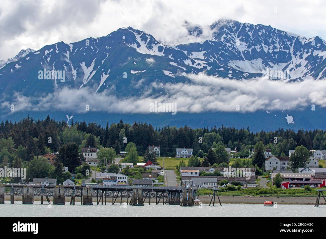 Mountain towering above Haines Stock Photo