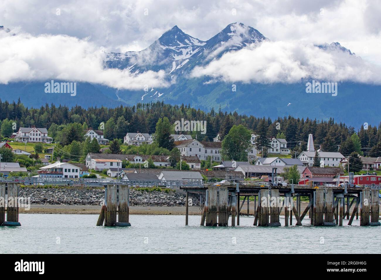 Mountains towering above Haines Stock Photo