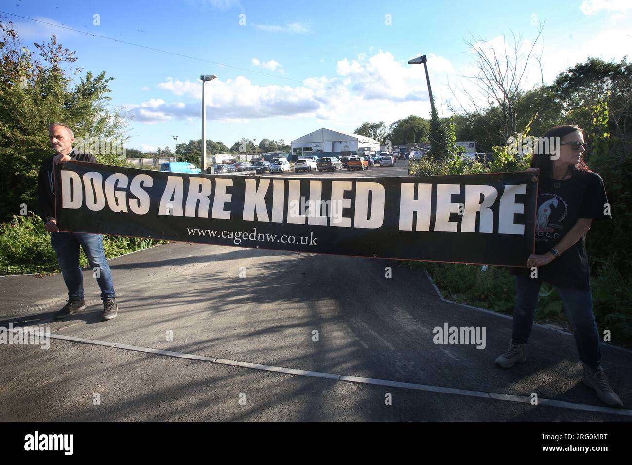 Henlow, UK. 06th Aug, 2023. Protesters hold a banner outside the dog stadium saying 'Dogs Are Killed Here' during the demonstration. Animal Rights activists protest outside Henlow dog racing track. They are aiming to highlight the cruelty associated with dog racing. In 2021 there were 4422 injuries and 120 deaths on registered greyhound race tracks in the UK. Credit: SOPA Images Limited/Alamy Live News Stock Photo