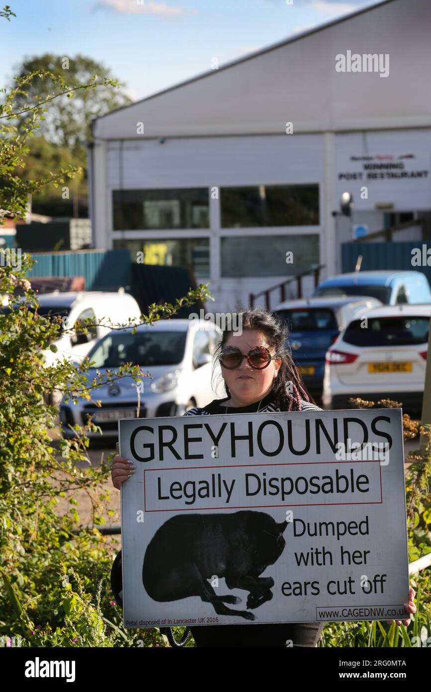 Henlow, UK. 06th Aug, 2023. A protester holds a placard saying 'Greyhounds Legally Disposable' outside the dog stadium during the demonstration. Animal Rights activists protest outside Henlow dog racing track. They are aiming to highlight the cruelty associated with dog racing. In 2021 there were 4422 injuries and 120 deaths on registered greyhound race tracks in the UK. Credit: SOPA Images Limited/Alamy Live News Stock Photo