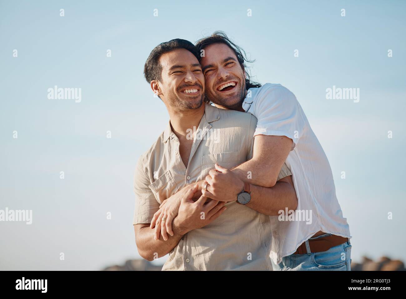 Love, hug and gay men with blue sky, embrace and smile on summer vacation together in Thailand. Sunshine, romance and marriage, happy lgbt couple Stock Photo