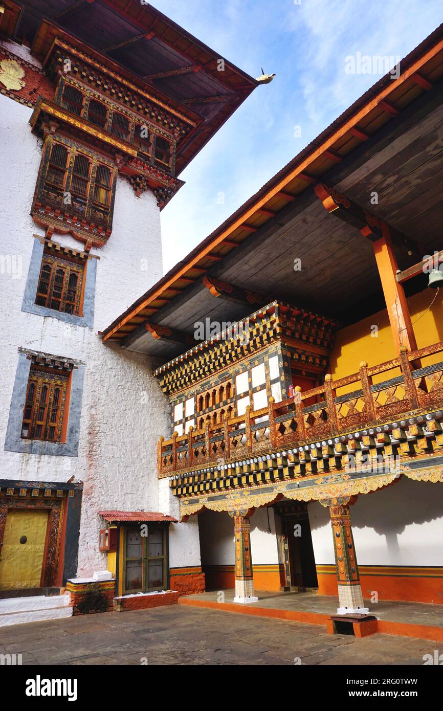 Traditional Bhutanese architecture featuring painted woodwork, banks of ornate rabsel windows and whitewashed stone masonry at Punakha Dzong, Bhutan Stock Photo