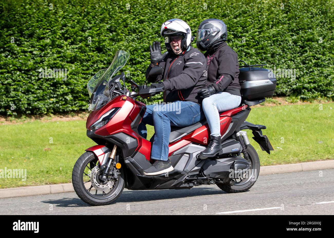 Whittlebury,Northants.,UK - Aug 6th 2023. Red 2023 Honda ADV 350 A-P  motorcycle travelling through an English village Stock Photo - Alamy