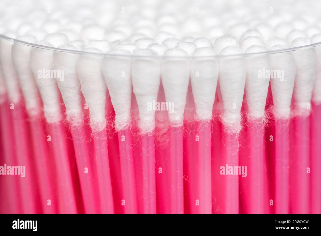 Many white cotton sticks. Round container with cotton buds Stock Photo