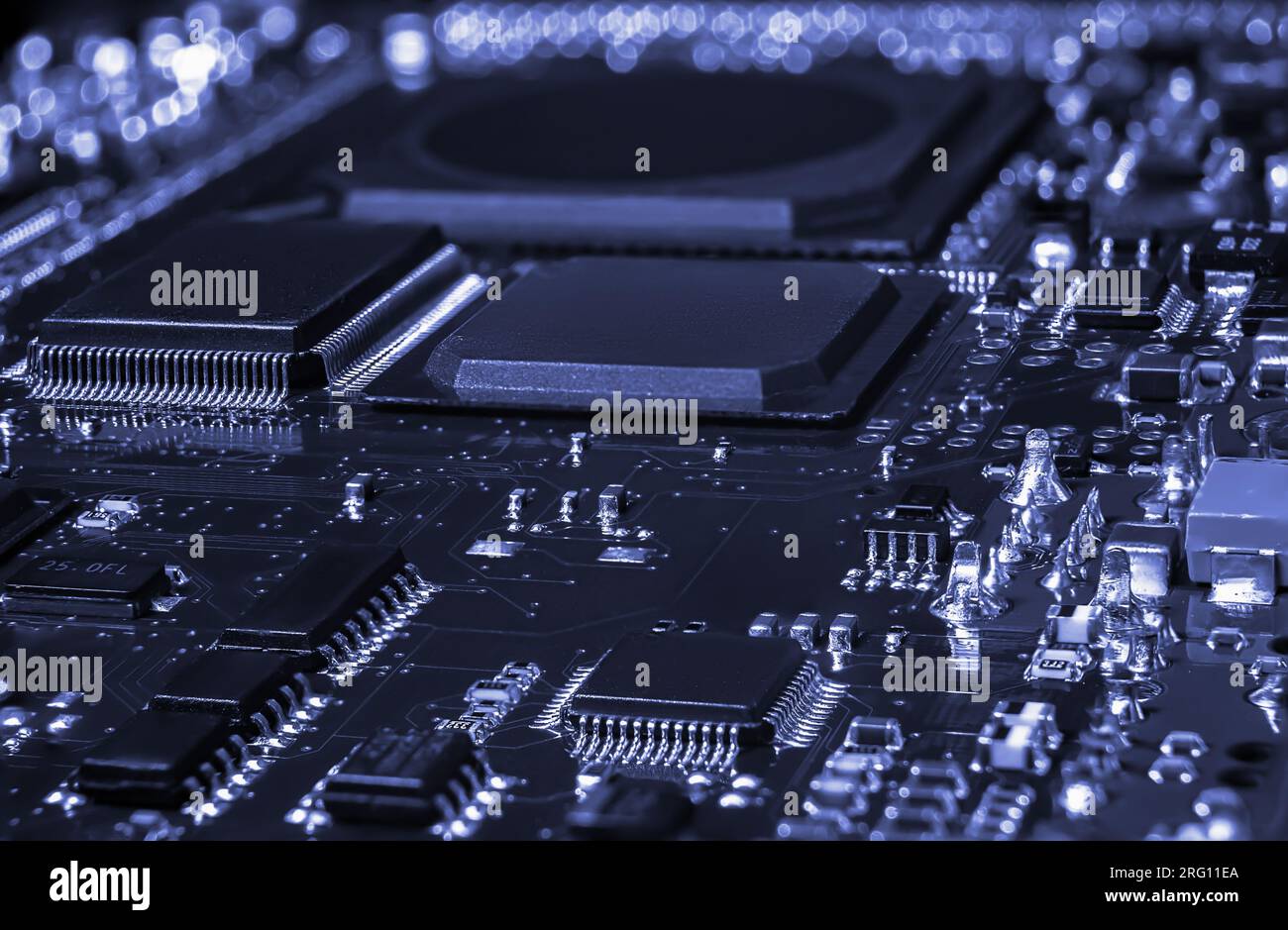 Intricate circuit board with computer hardware, showcasing complexity of electronics industry. Stock Photo