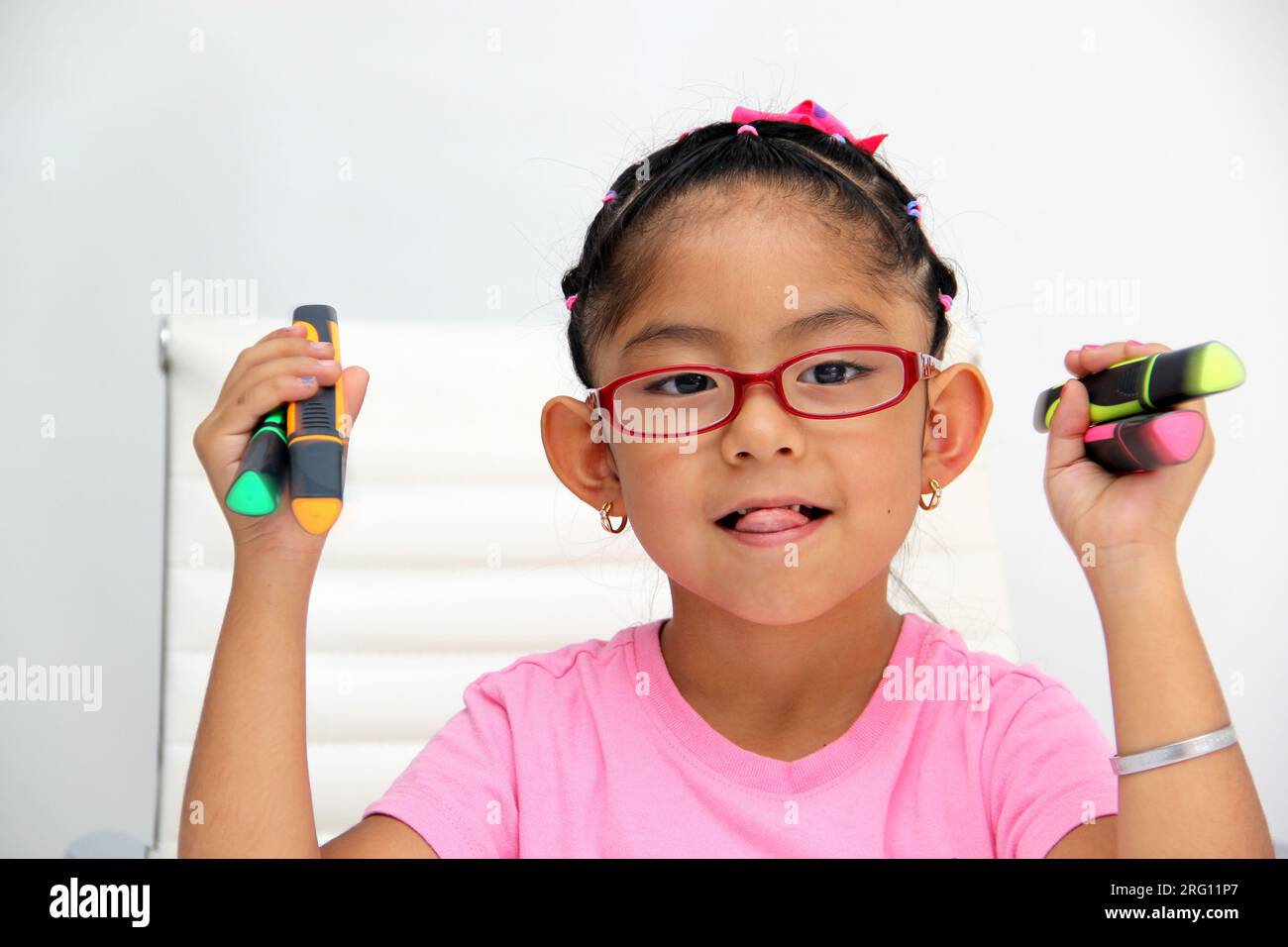 4-year-old brunette Latina girl with autism spectrum disorder ASD like Asperger, Rett and Heller draws at a desk, plays with colors alone antisocial Stock Photo