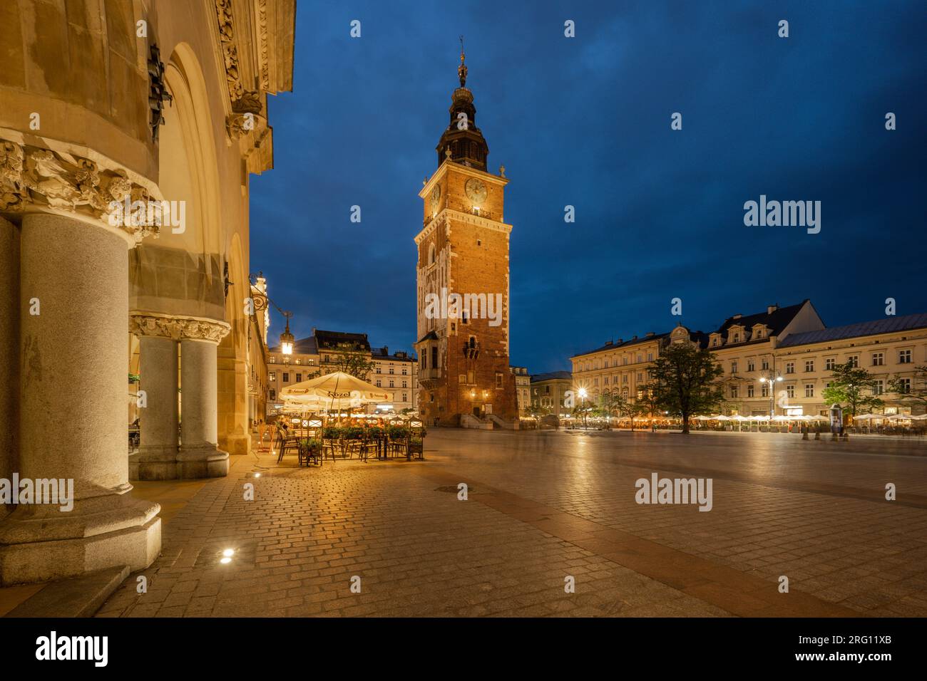 Main Market Square (Rynek Glowny) with Sukiennice (Cloth Hall) and St. Mary's (Mariacki) Church, Poland, Krakow. Stock Photo