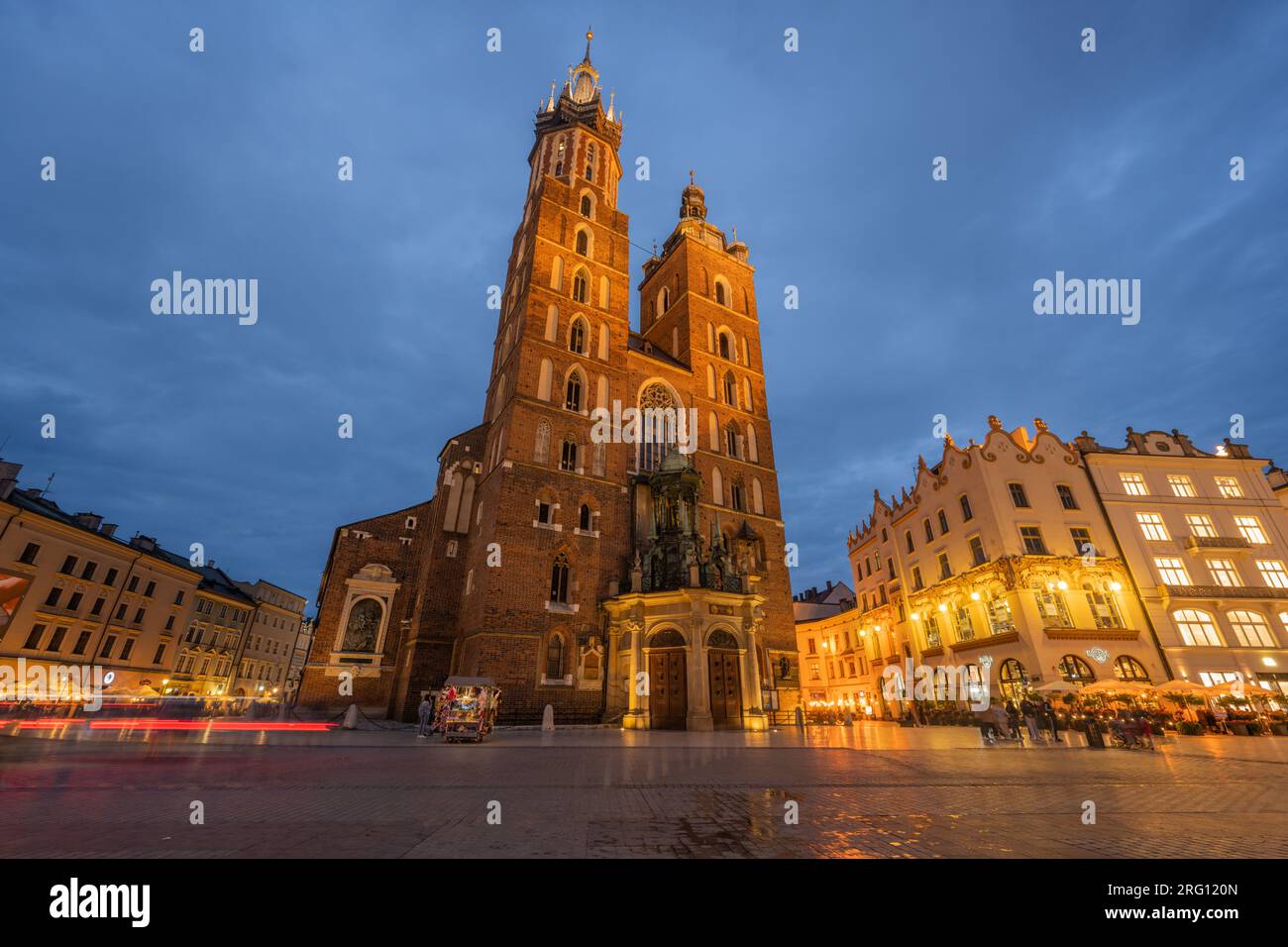Main Market Square (Rynek Glowny) with Sukiennice (Cloth Hall) and St. Mary's (Mariacki) Church, Poland, Krakow. Stock Photo