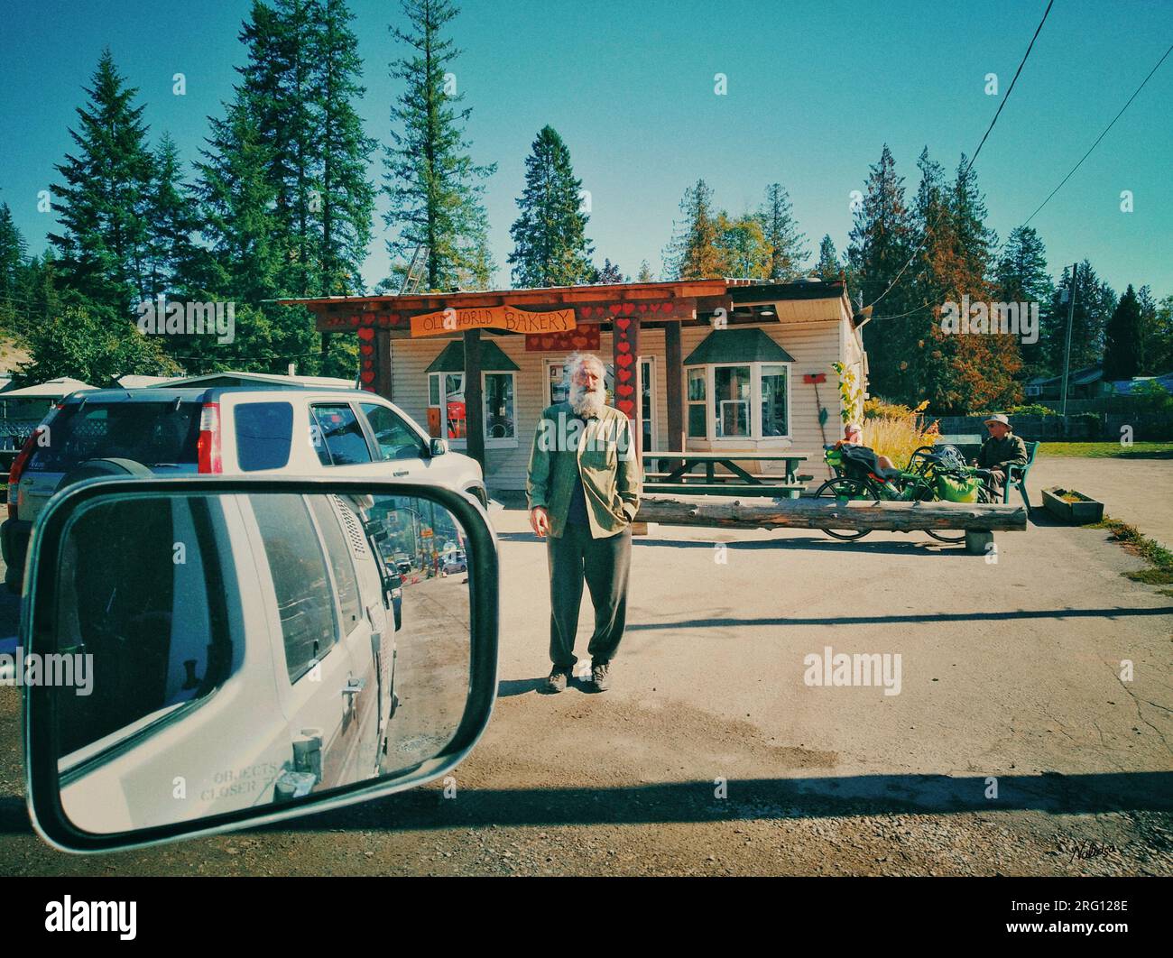 British Columbia, Canada - September 25, 2021: View from side view mirror over looking street scene and landscape near Ferry Landing Road, Balfour, BC Stock Photo