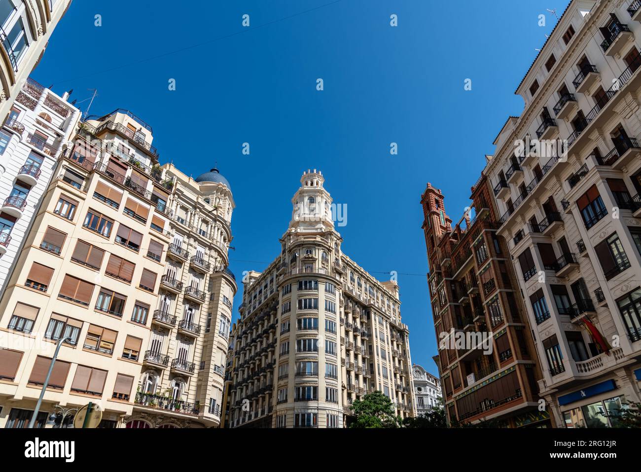 Valencia, Spain - July 29, 2023: Residential building in the square of the town hall in the center of the city. View against blue sky Stock Photo