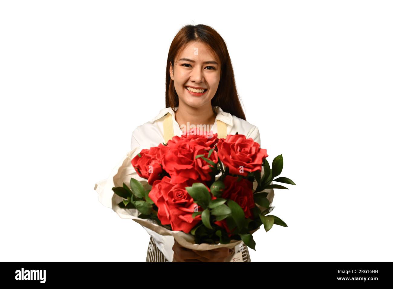 Cheerful young woman florist holding beautiful bouquet of red roses ...