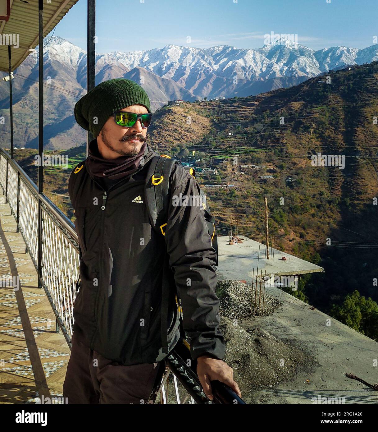 October 14th 2022 Uttarakhand, India. Ready solo traveler with backpack,  gazing from homestay balcony at snow-capped Mussoorie mountains, Uttarakhand  Stock Photo - Alamy