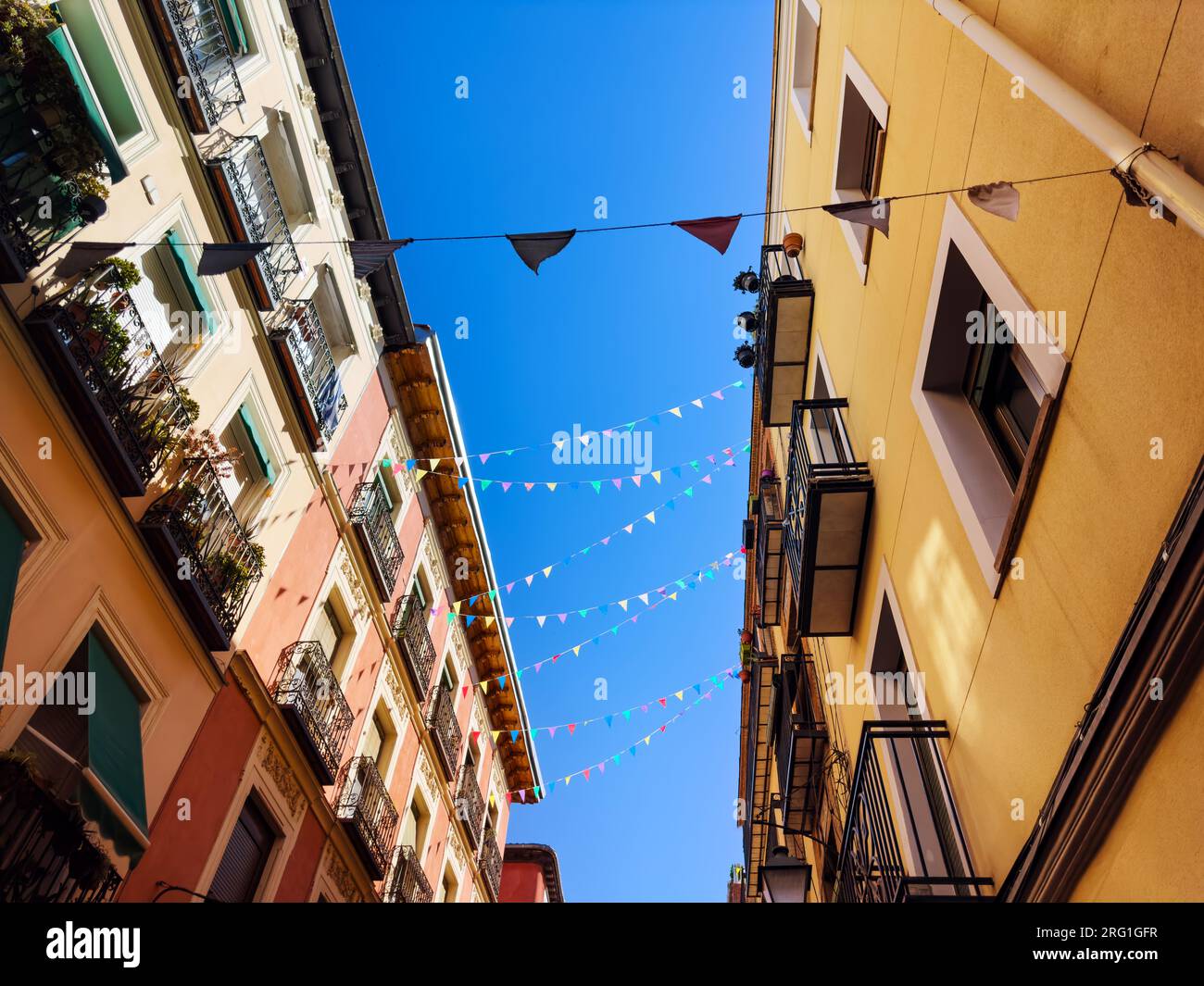 Colorful flags on old town Sombrerete street of Madrid downtown Stock Photo