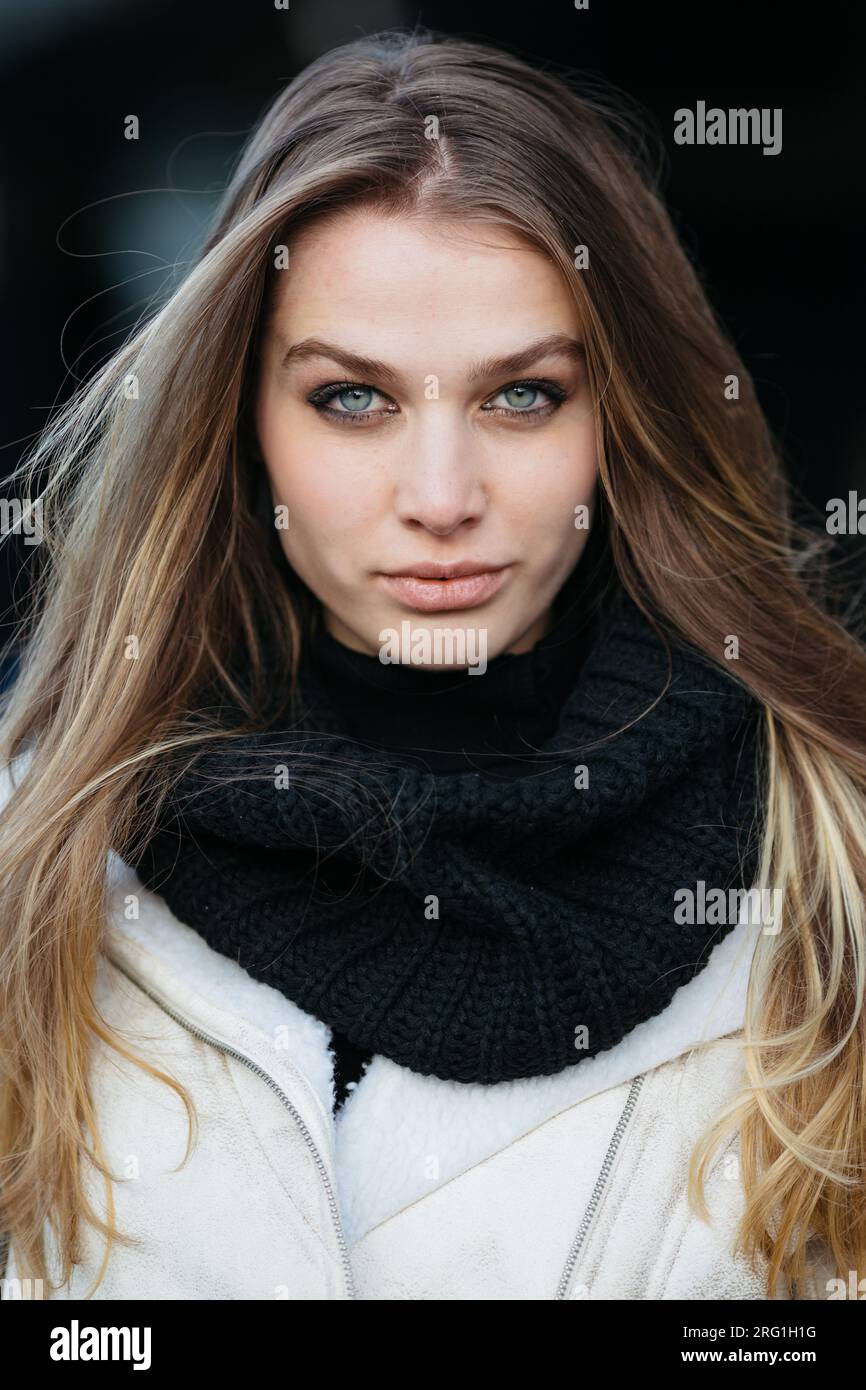 Close-up portrait of young beautiful woman wearing black scarf Stock Photo