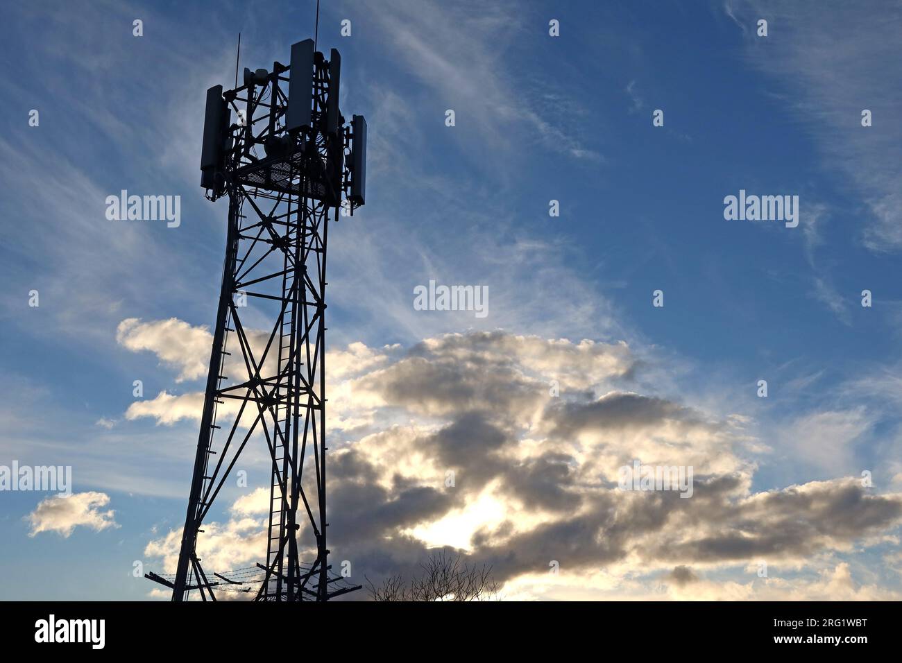 Mobile phone cellular mast against a moody dramatic sky, Heptonstall, Hebden Bridge, Calderdale, West Yorkshire, England, UK, HX7 7LT Stock Photo