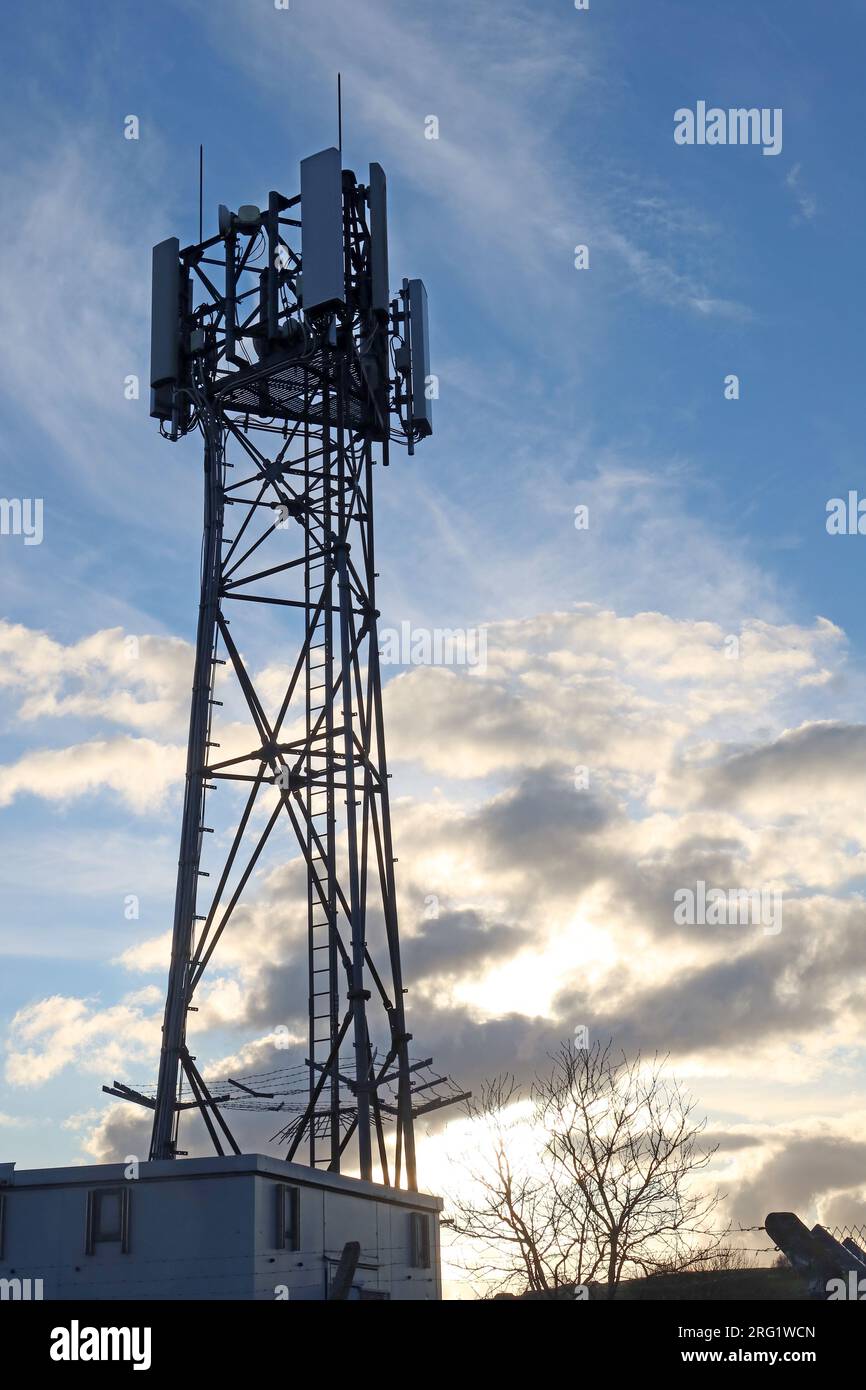 Mobile phone cellular mast against a moody dramatic sky, Heptonstall, Hebden Bridge, Calderdale, West Yorkshire, England, UK, HX7 7LT Stock Photo