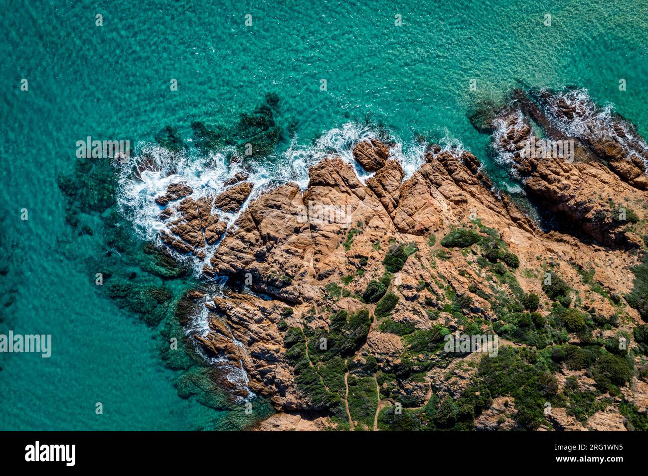 Aerial view of beautiful rocky coast. Turquoise sea and rocks.  Drone Top down view of sea crystal water and cliffs shore, South Sardinia, Italy.  Med Stock Photo