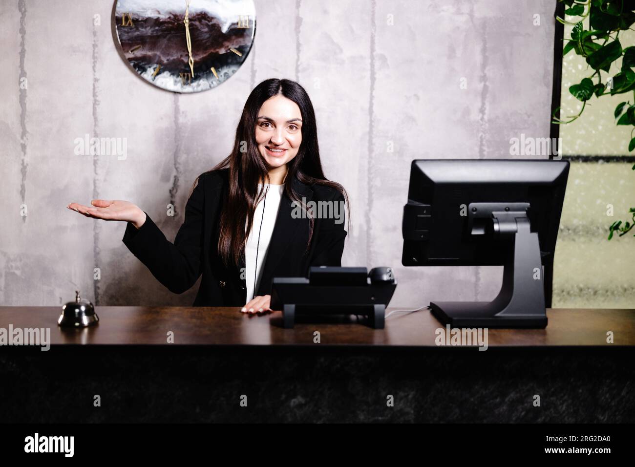 Portrait of receptionist at desk in lobby. Banner design. Friendly