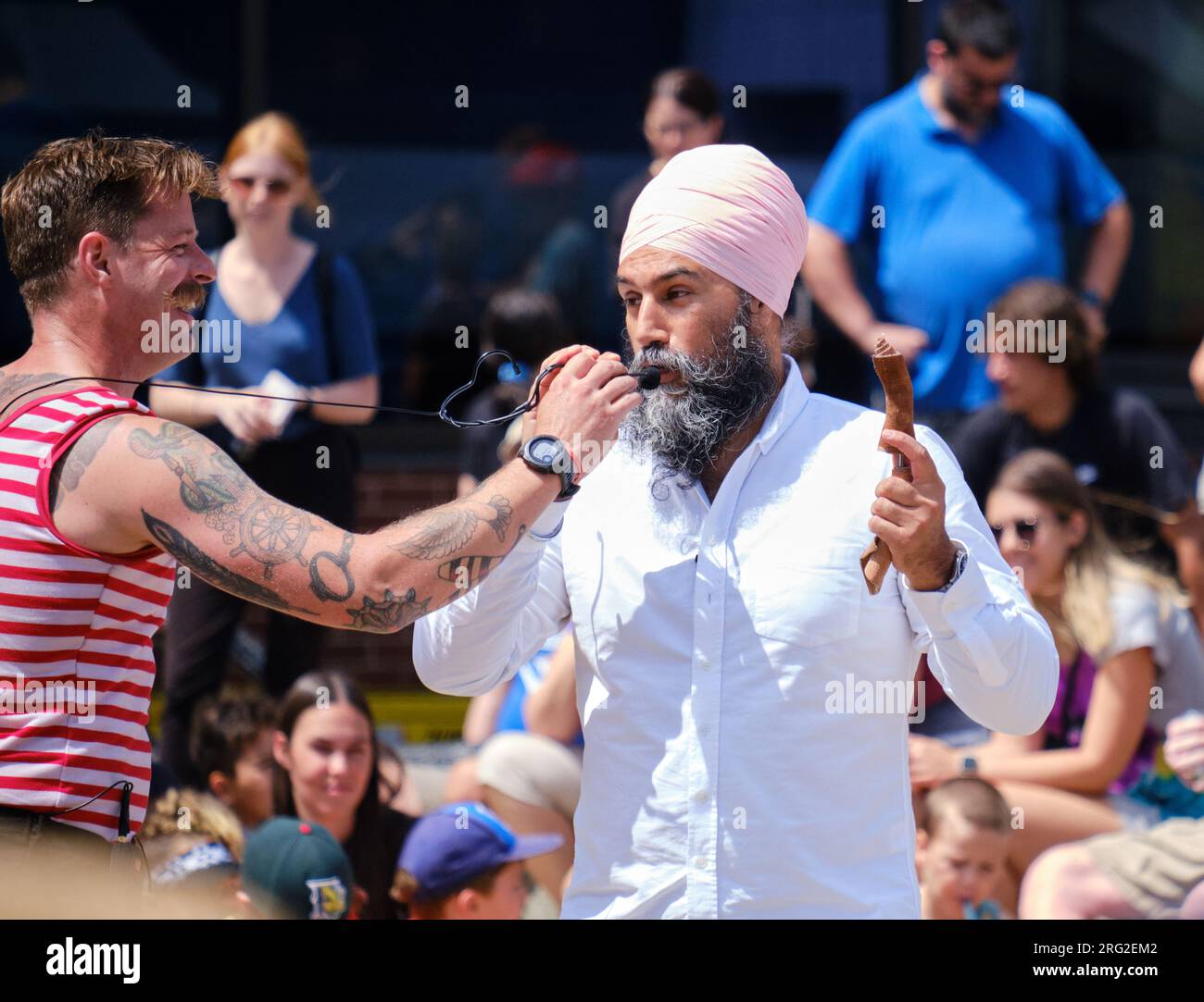 NDP Leader Jagmeet Singh playfully volunteering for busker Mighty Mike at the Halifax Busker Festival 2023 Stock Photo