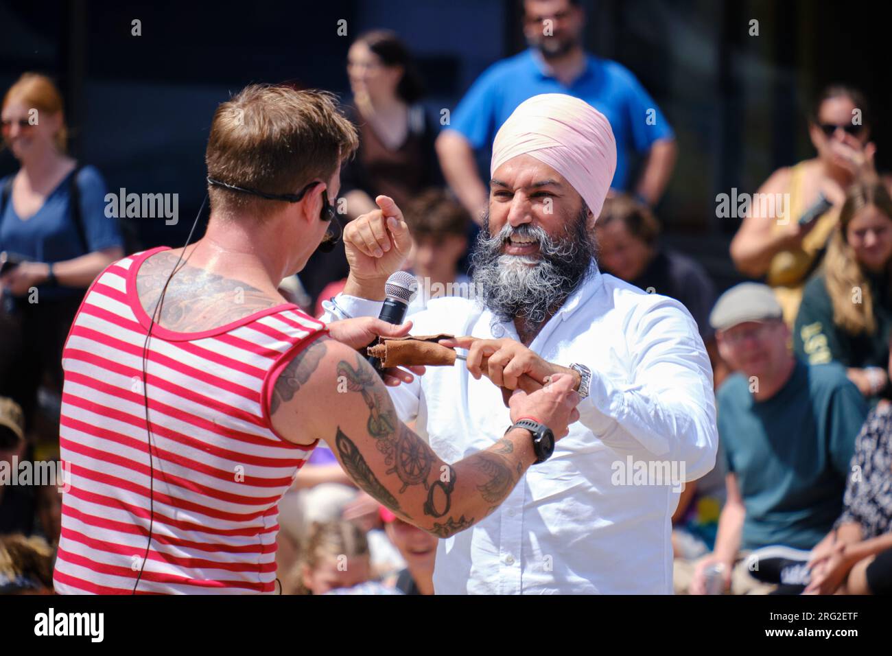 NDP Leader Jagmeet Singh playfully volunteering for busker Mighty Mike at the Halifax Busker Festival 2023 Stock Photo