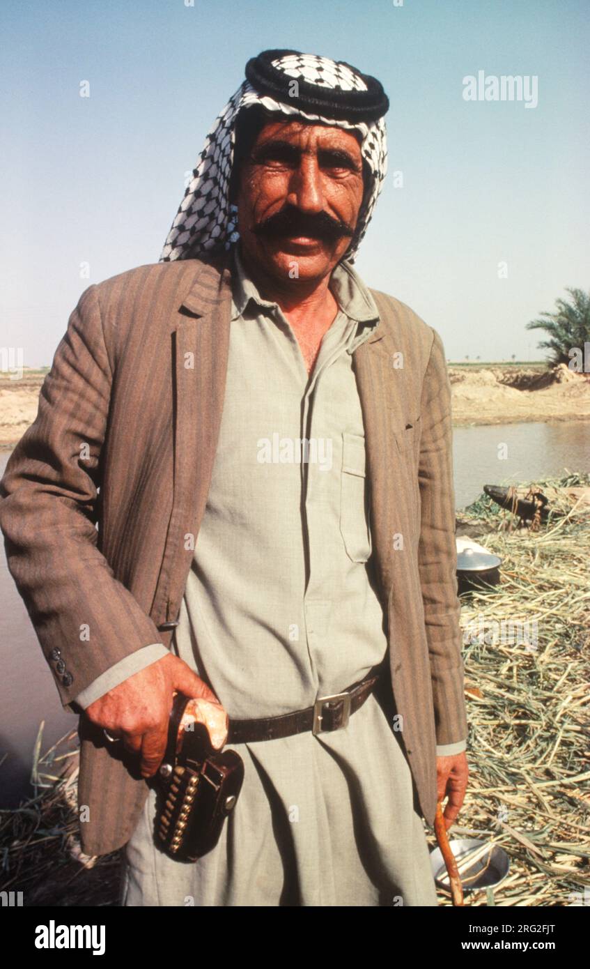 Marsh Arabs Southern Iraq 1980s. Marsh Arab man with gun used for  his own protection but shooting at wild life game for the pot. Hammar marshes Iraq 1984 HOMER SYKES Stock Photo