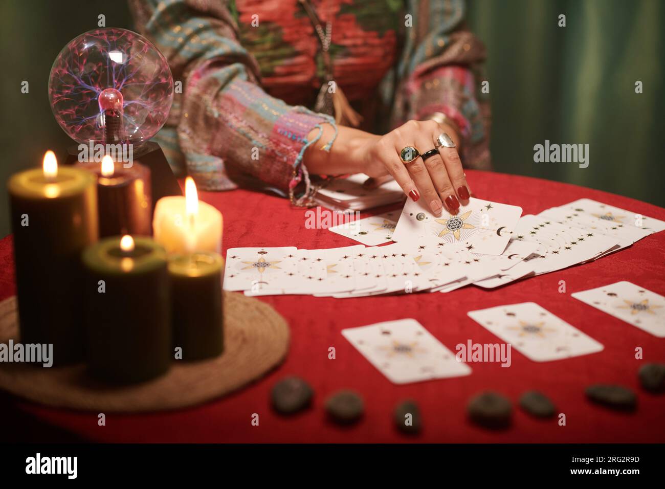 Hands of sorceress spreading tarot cards on table in front of her Stock ...