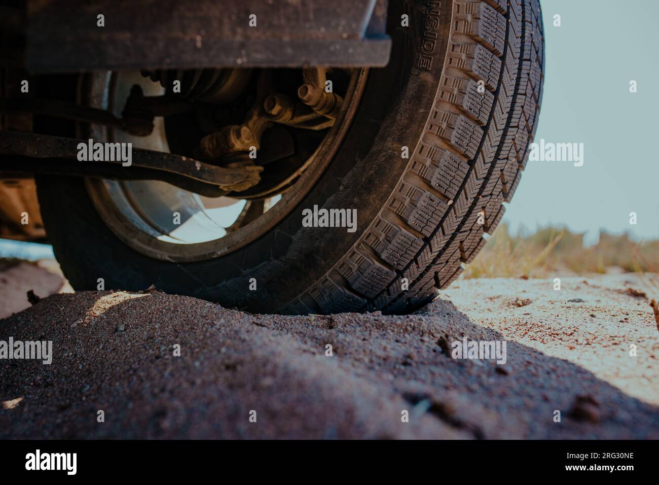 Car wheel on sand close-up view Stock Photo