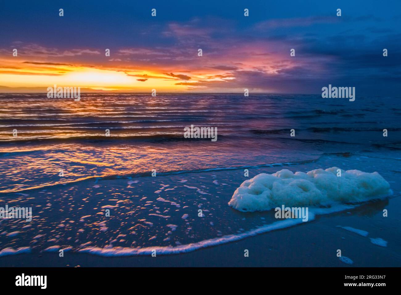 Sunset at north sea beach at coastline with low tide Stock Photo