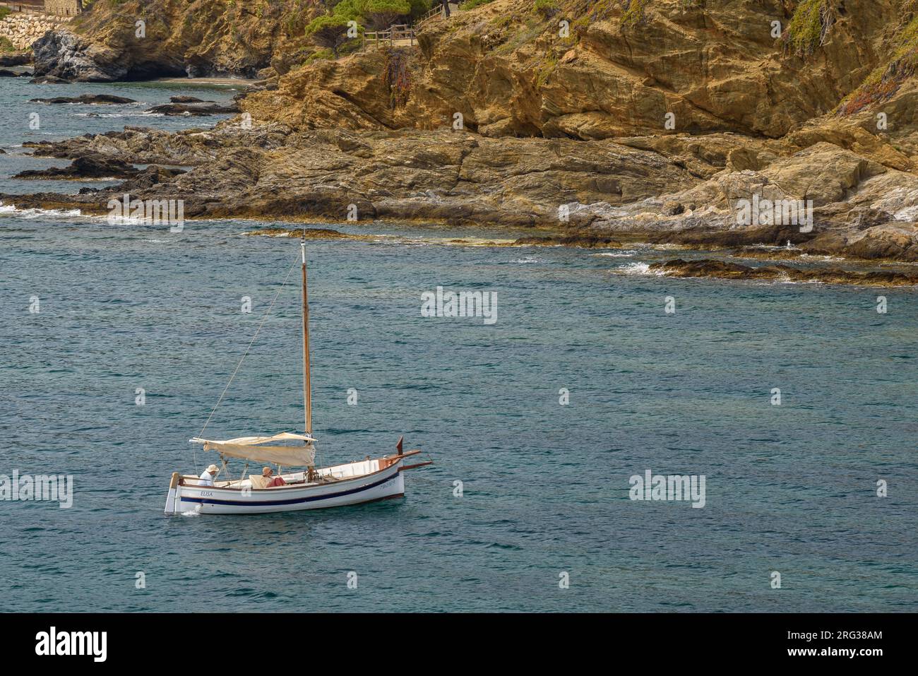 A boat sailing in the sea in the bay of Port de la Selva, north of Cap de Creus cape (Alt Empordà, Girona, Catalonia, Spain) Stock Photo