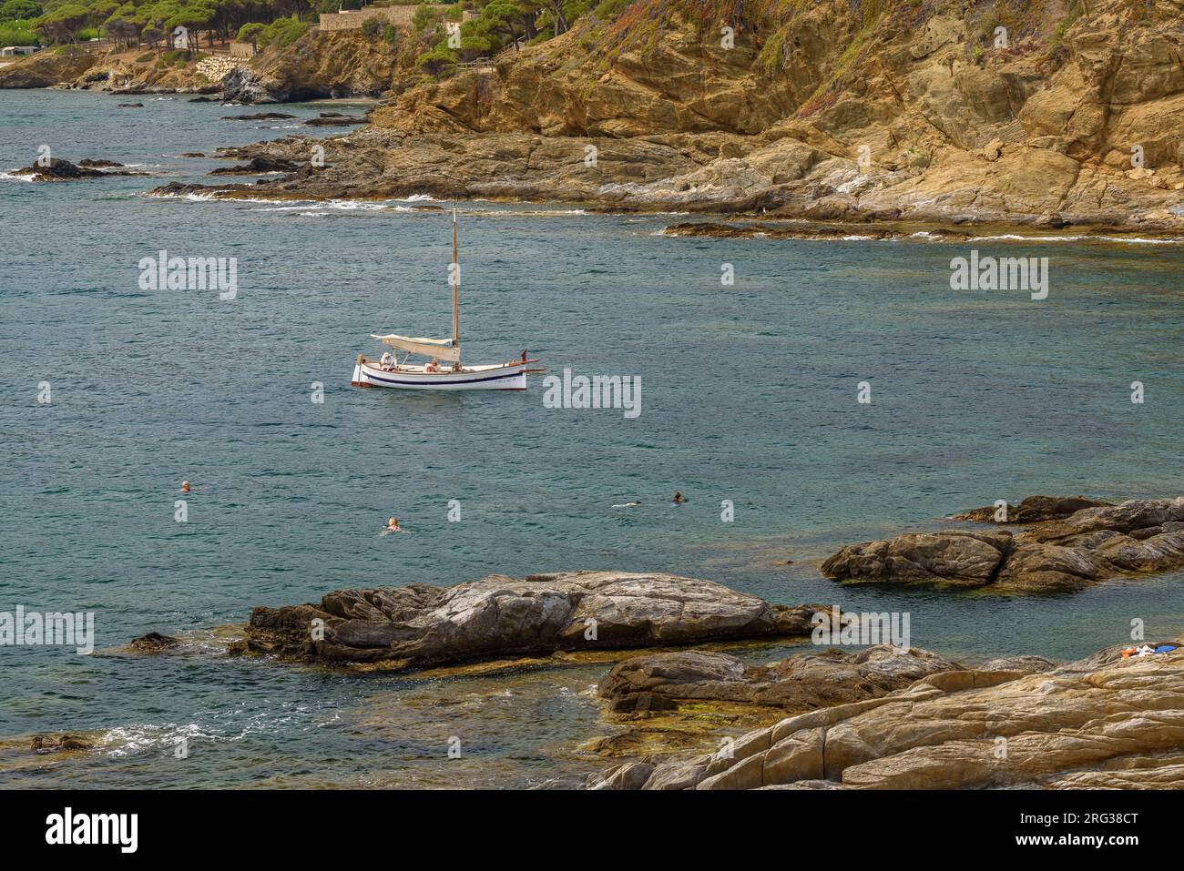 A boat sailing in the sea in the bay of Port de la Selva, north of Cap de Creus cape (Alt Empordà, Girona, Catalonia, Spain) Stock Photo
