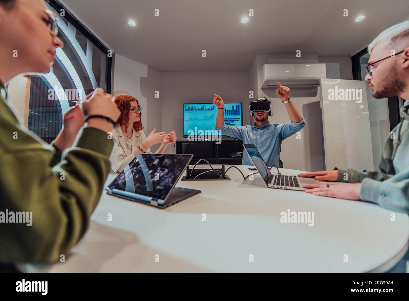 A diverse group of businessmen collaborates and tests a new virtual ...