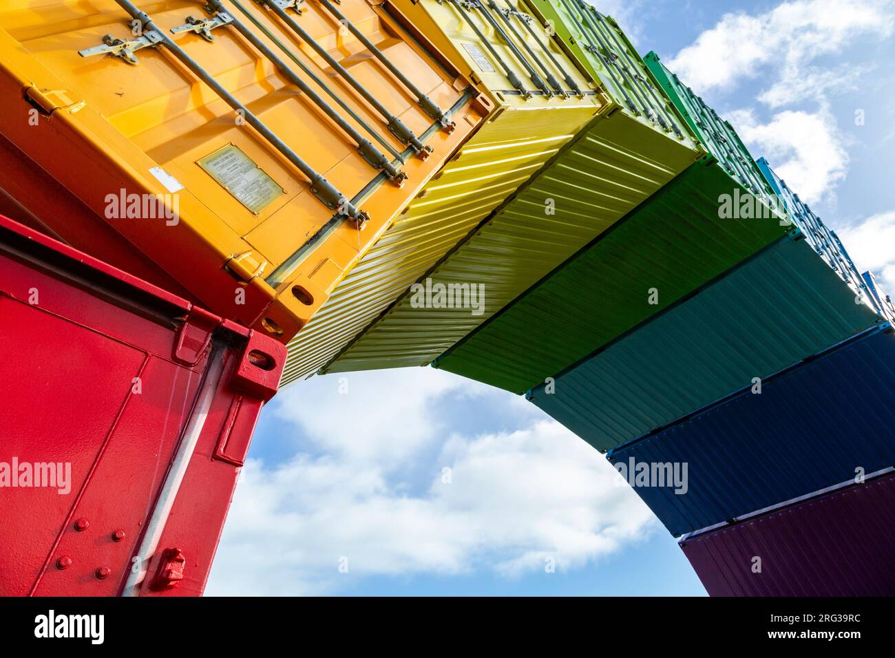 Containbow - a rainbow arch shipping container sculpture installation by Marcus Canning. Stock Photo