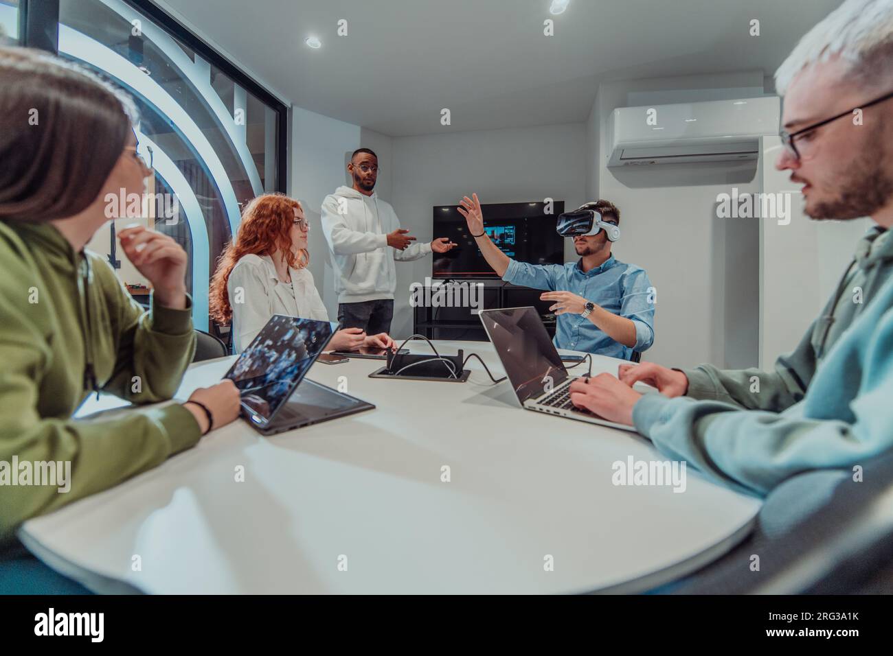 A diverse group of businessmen collaborates and tests a new virtual ...