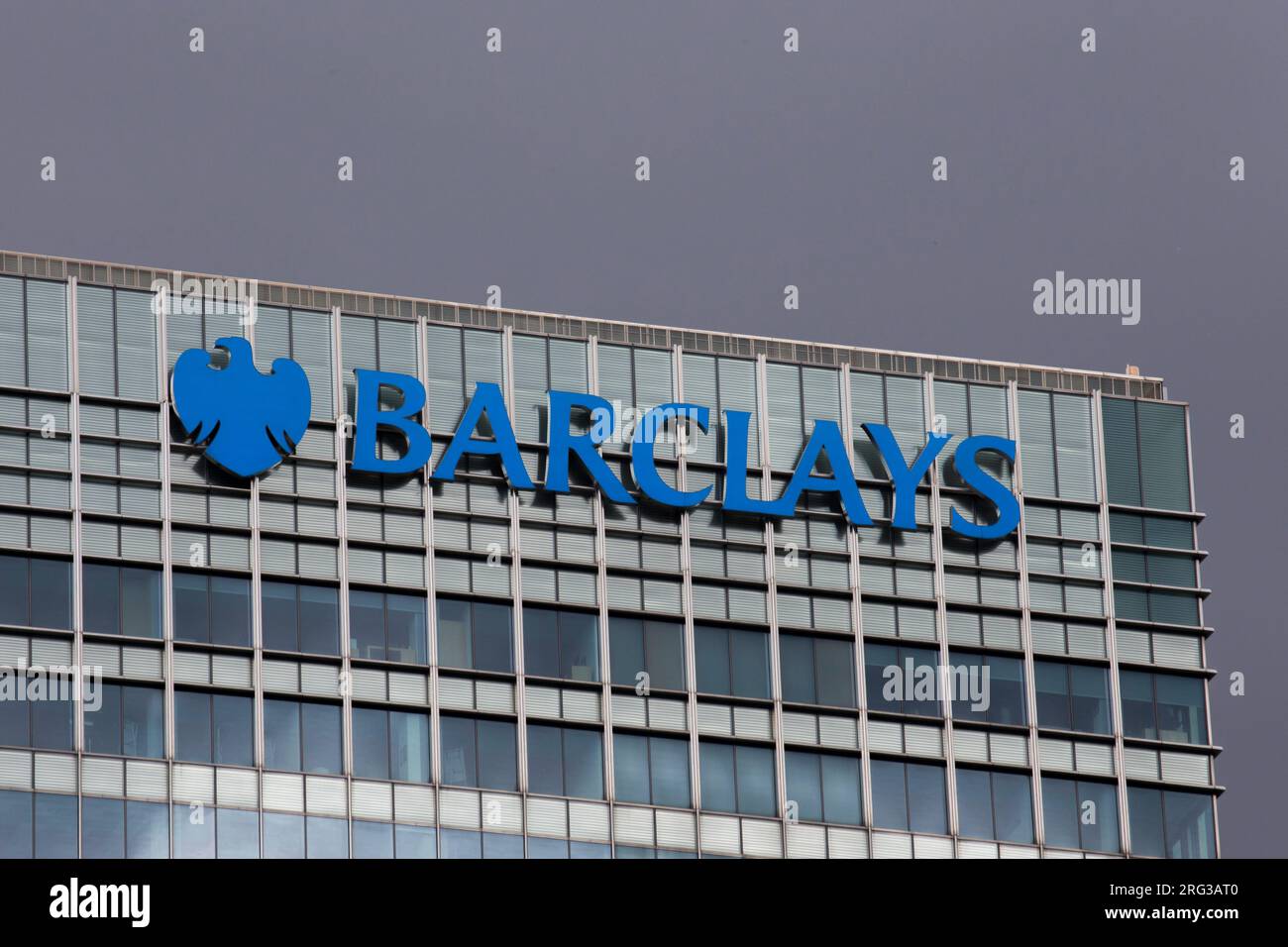 Moody Sky's over Barclays Bank Headquarters Logo Canary wharf Stock