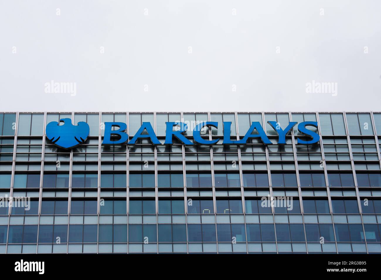 Moody Sky's over Barclays Bank Headquarters Logo Canary wharf Stock
