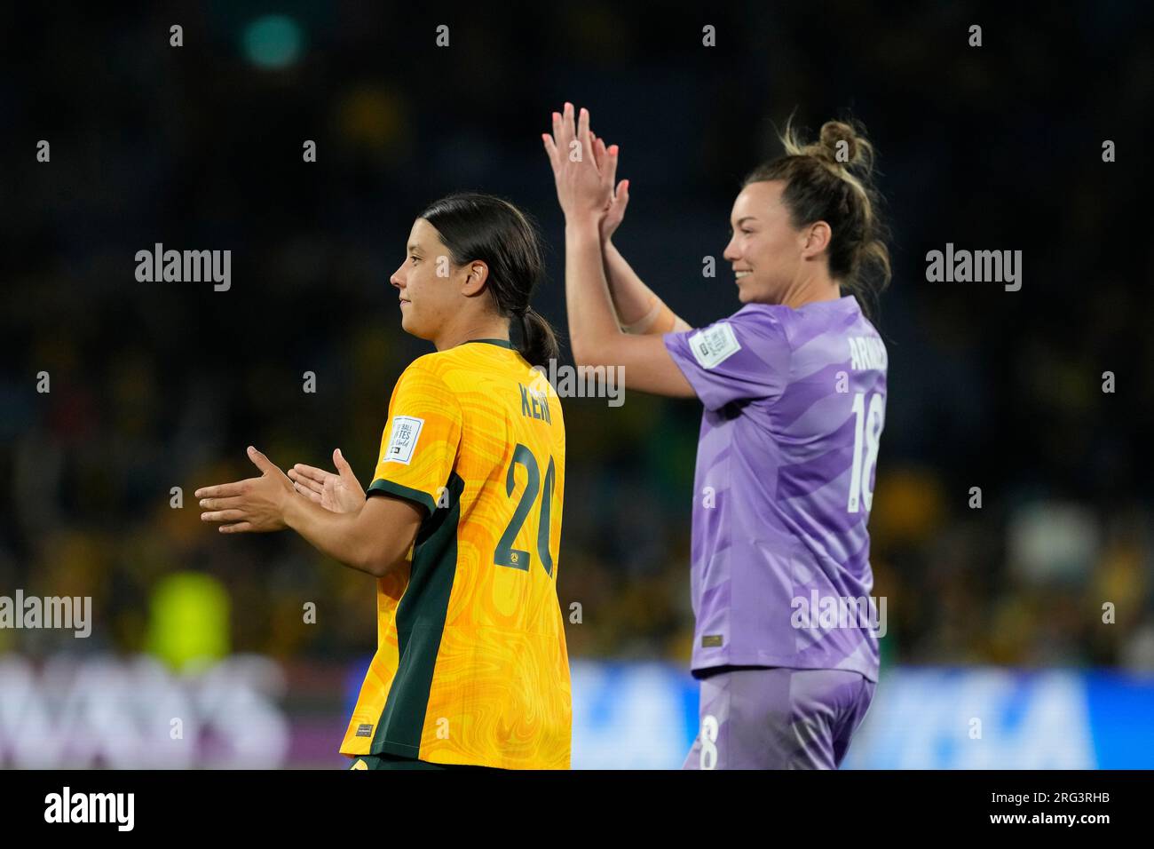 Australia's Sam Kerr, left, and goalkeeper Mackenzie Arnold applaud