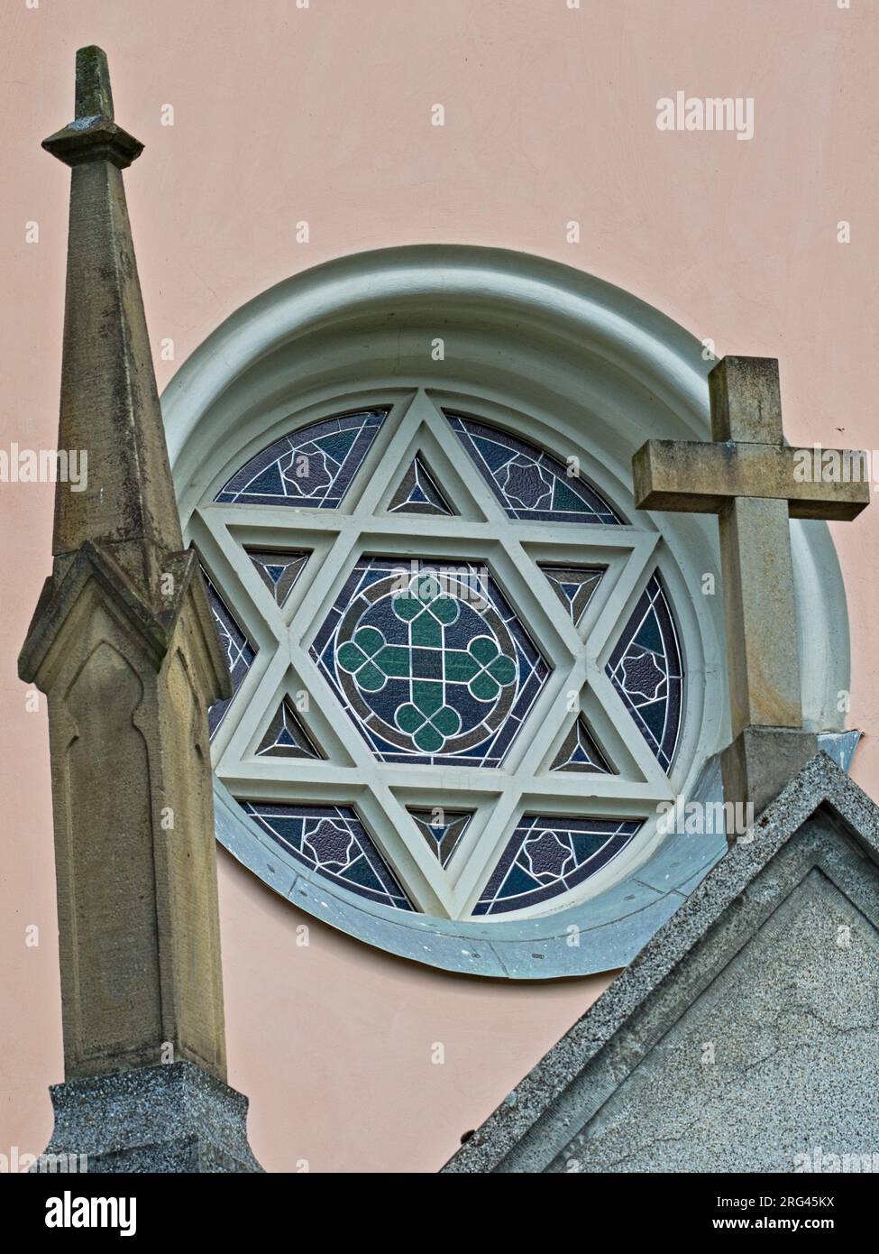 Religion symboles on a church in village Vidče near to Rožnov pod Radhoštěm in Czech republic. Concrete cross and six-pointed star aka hexagram. Stock Photo