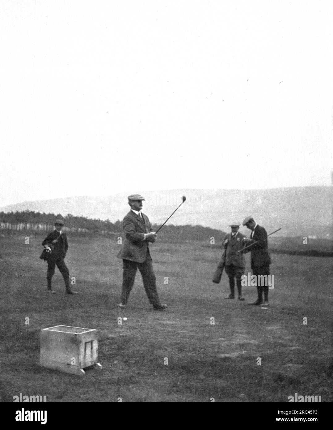 circa 1910, historical, about to hit a ball from a tee, J H Taylor, a famous English professional golfer of this era. Between 1894 and 1913, Taylor was the winner of five British Open Championships and one of the pioneer's of the modern game. In 1901 he was a co-founder of the British Professional Golfer's Association. Stock Photo
