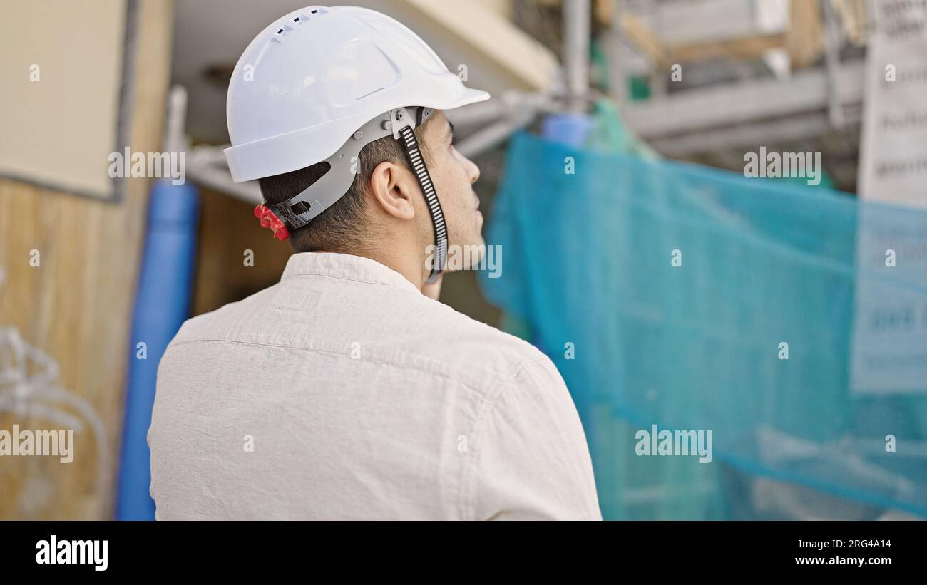 Young hispanic man architect talking on smartphone at street Stock Photo