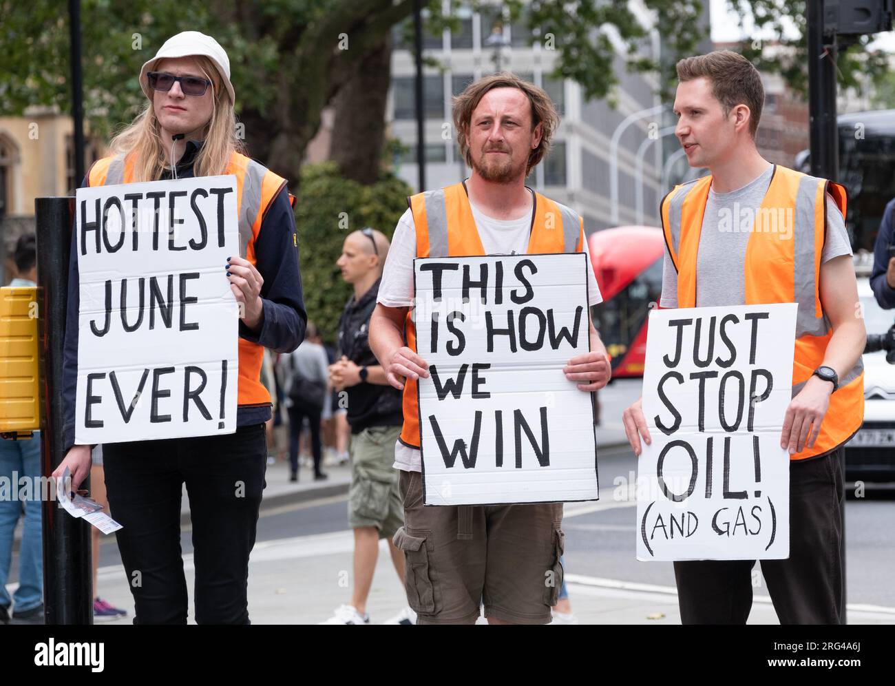 Just Stop Oil activists holding protest signs in central London