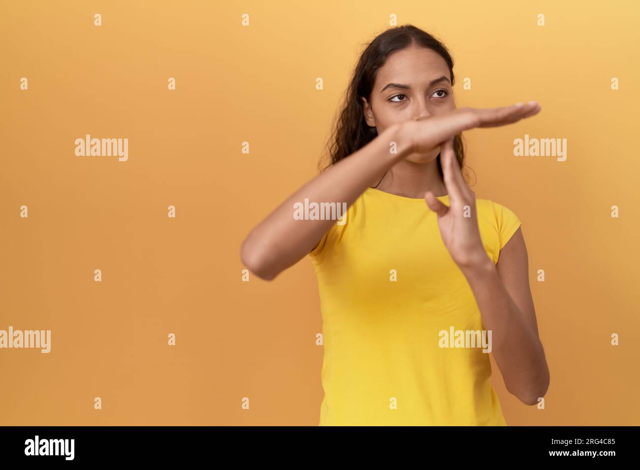 Young african american woman doing timeout gesture with hands over isolated yellow background Stock Photo