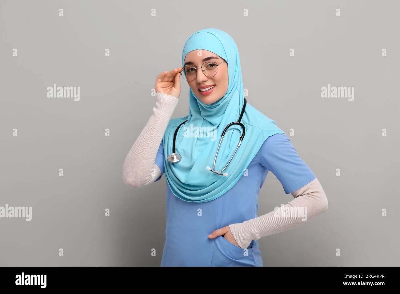 Muslim woman wearing hijab, medical uniform with stethoscope on light