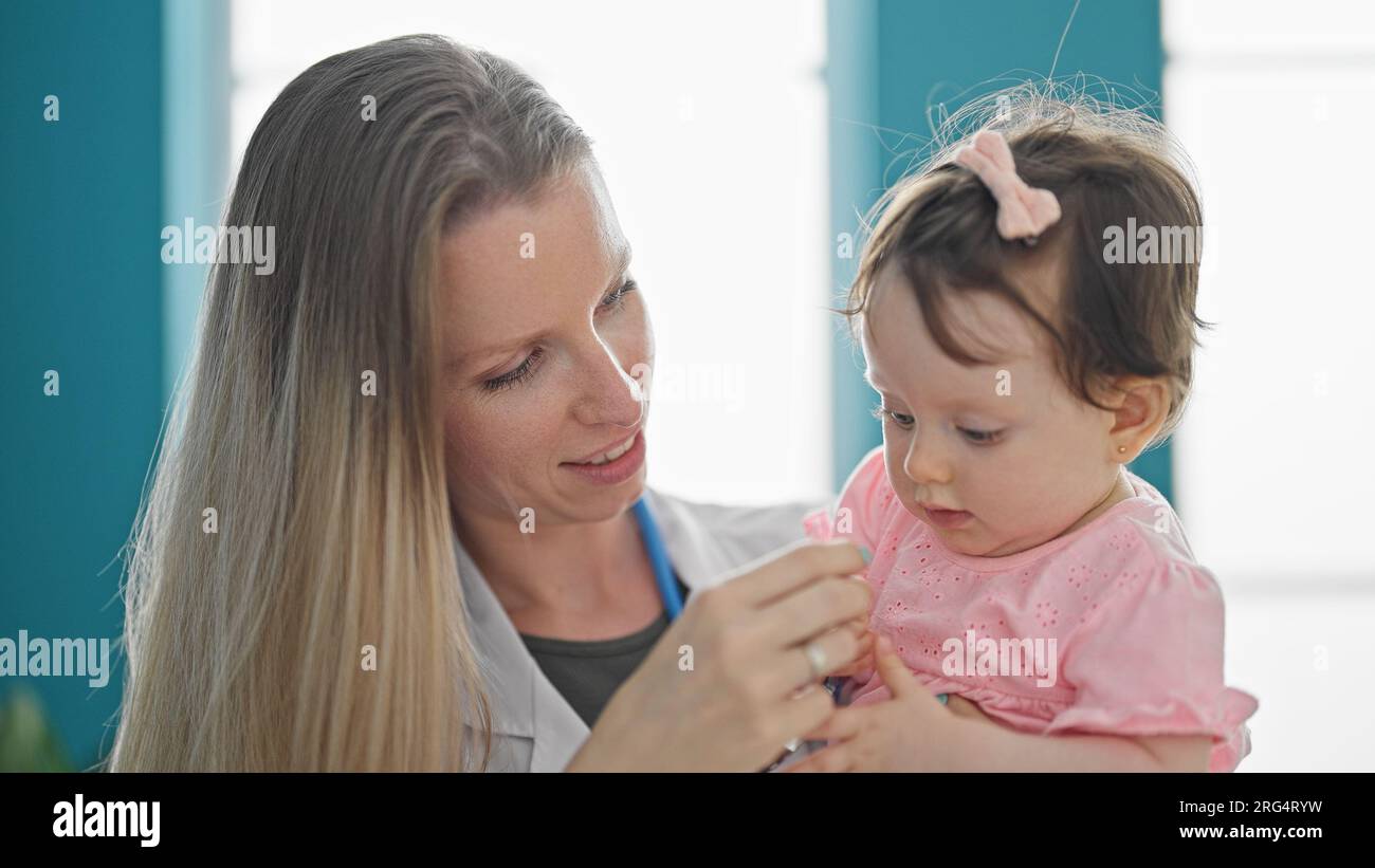 Mother and daughter playing with stethoscope at clinic Stock Photo - Alamy