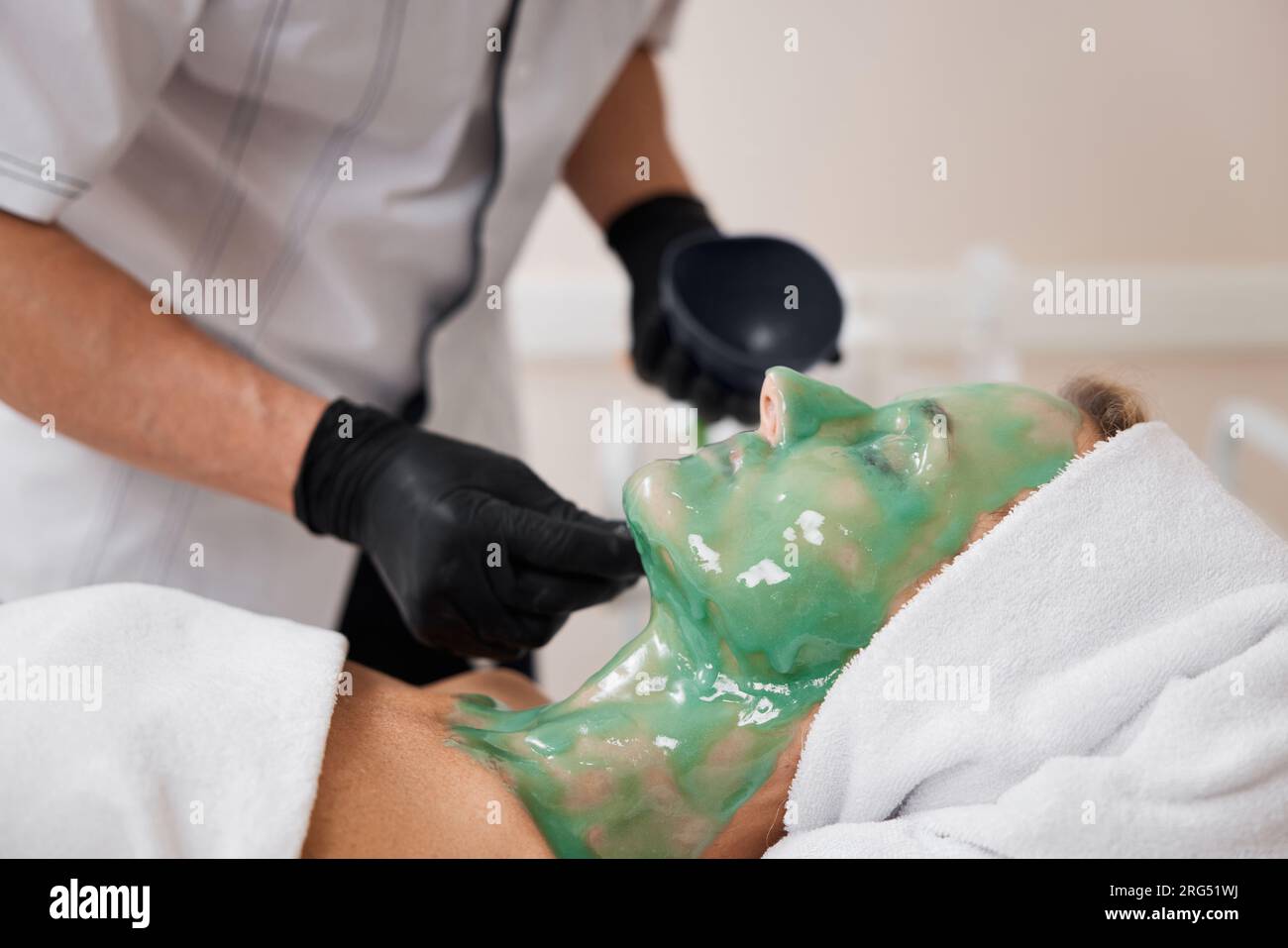 Professional applies face mask woman hi-res stock photography and ...