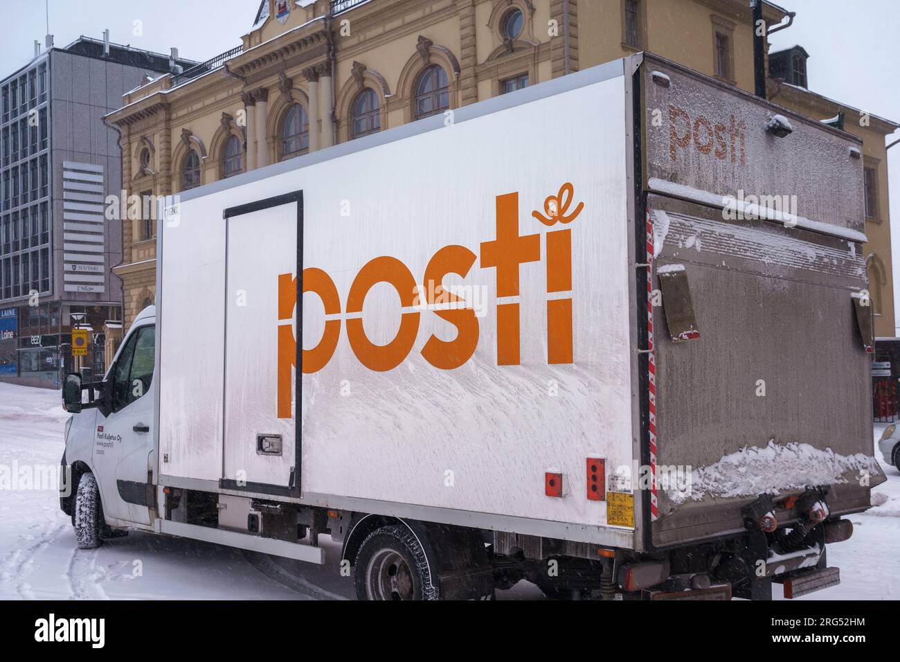 Delivery truck of the Posti group, the main Finnish postal service parked on the street in winter. Hameenlinna, Finland. February 23, 2023. Stock Photo