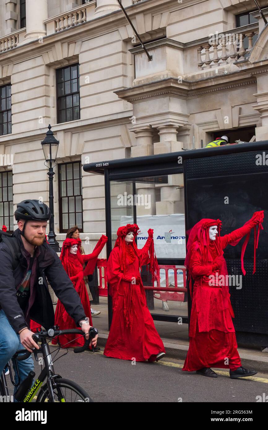 London, UK, 2023. On Whitehall, red-robed members of performance troupe Red Rebel Brigade march towards Westminster to join the mass protest Stock Photo